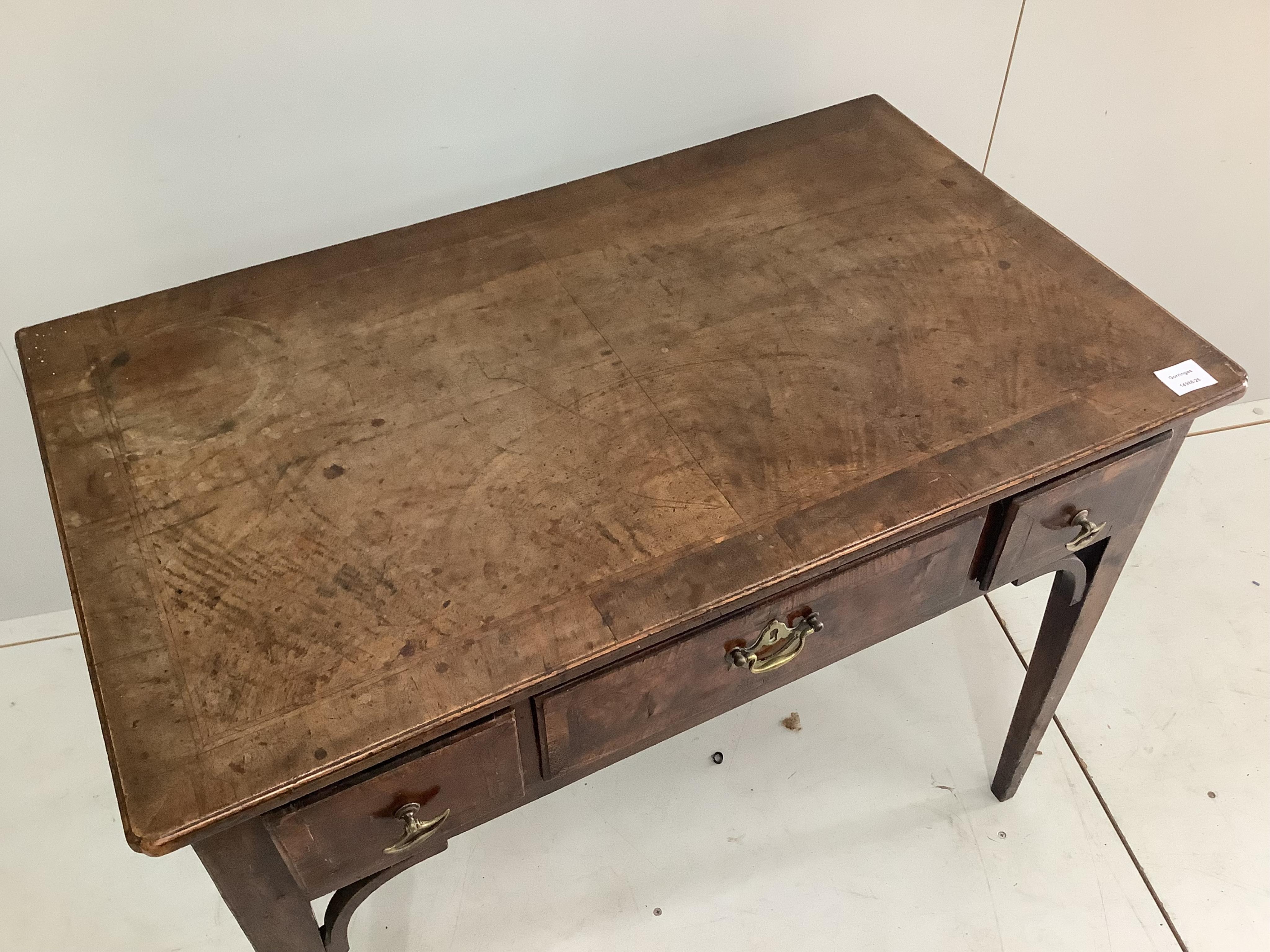 A George III feather banded mahogany three drawer side table, width 91cm, depth 54cm, height 71cm. Condition - fair